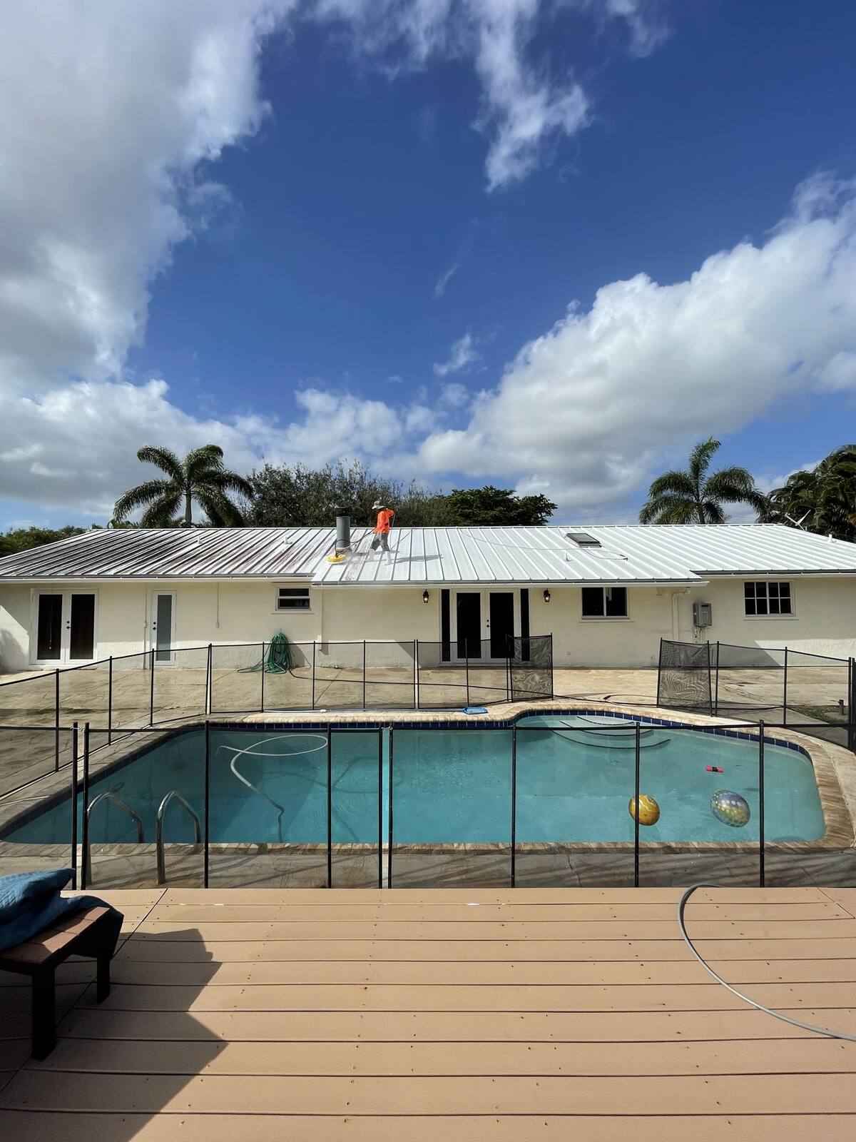 Clean metal roof and screened pool in Coral Springs, FL