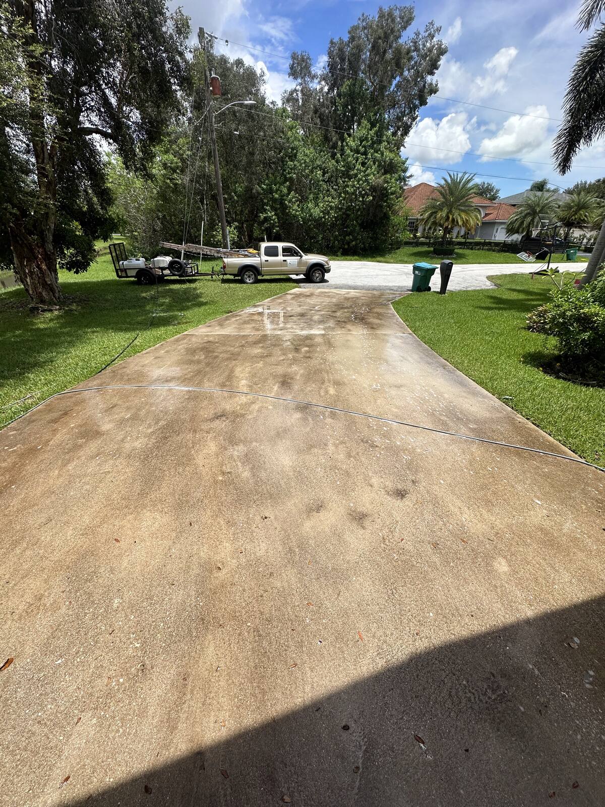 Rust-stained concrete driveway in South Florida — before