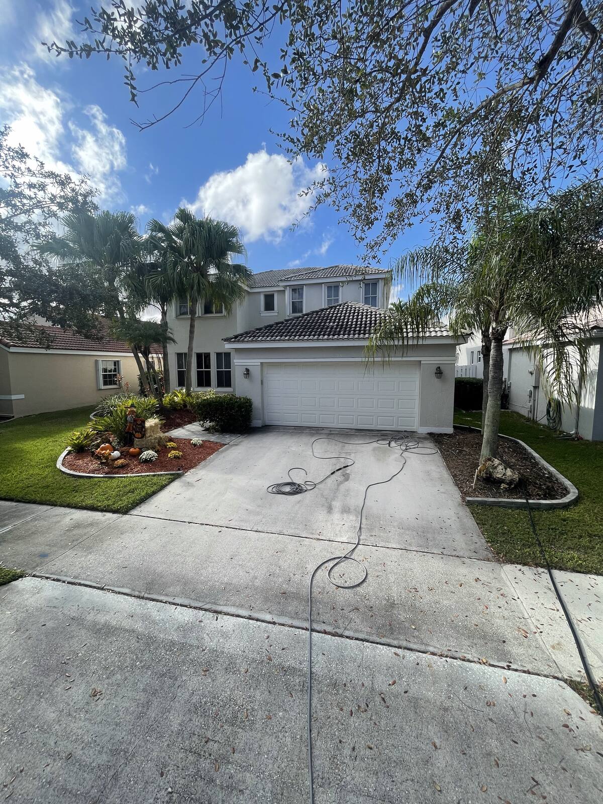 Concrete driveway pressure washing in South Florida — before