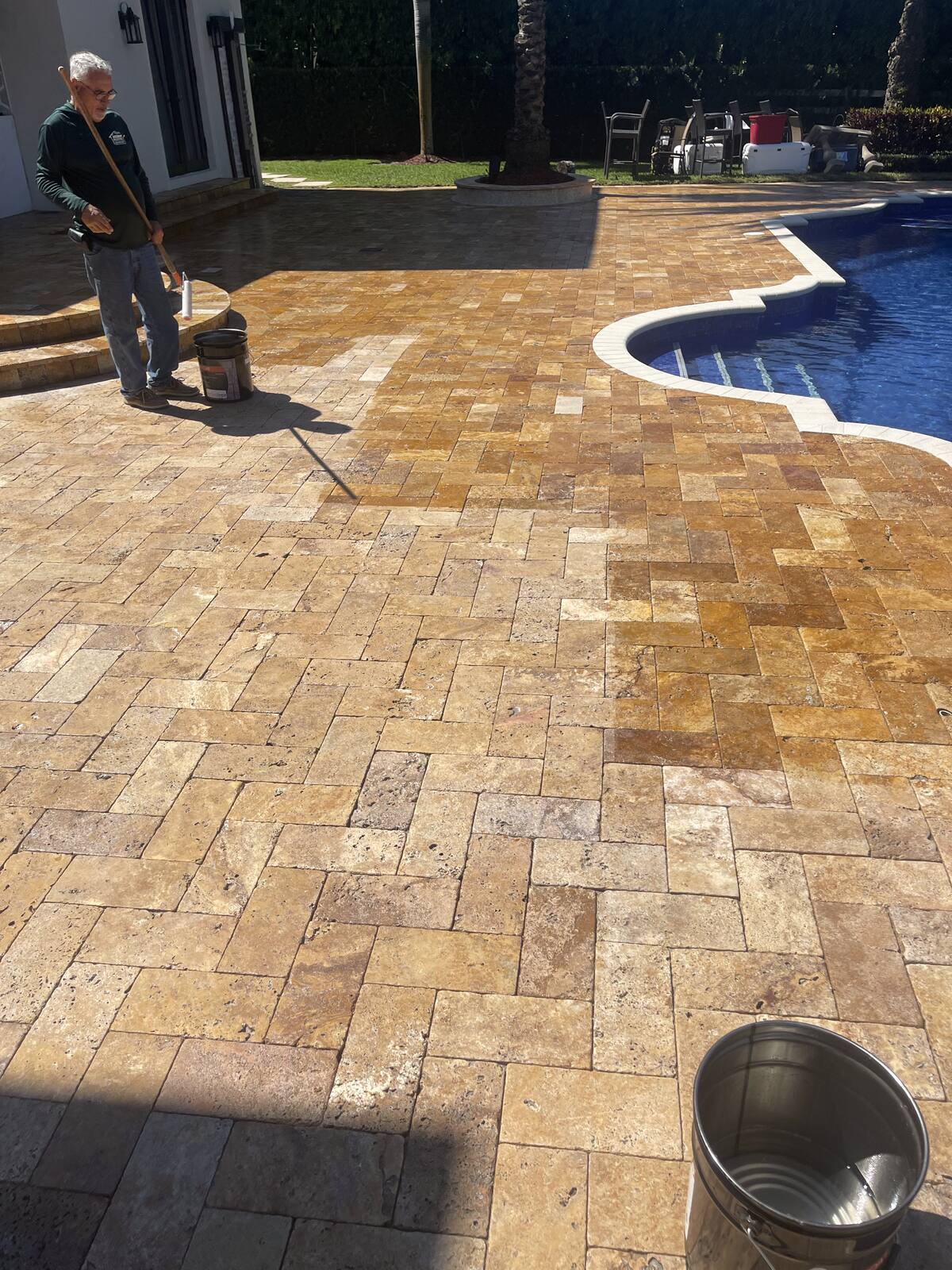 Stained travertine pool deck in South Florida — before