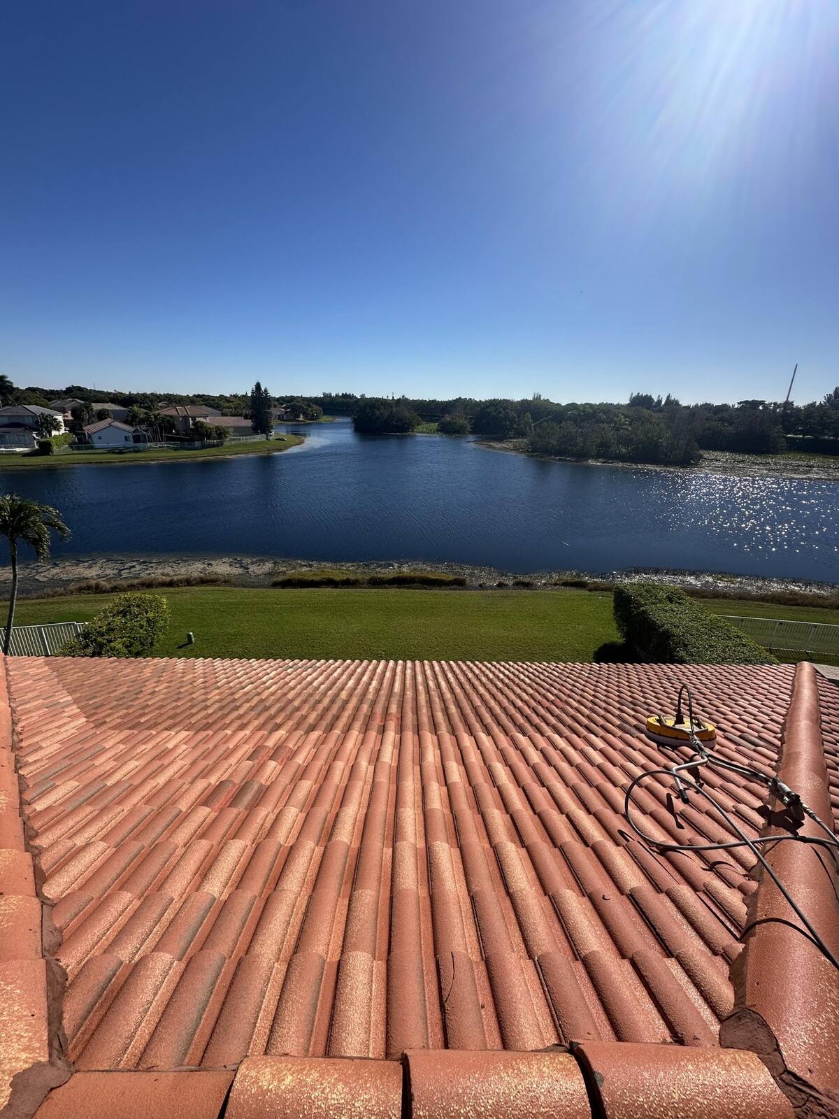 Clean barrel-tile roof on a South Florida lakefront home