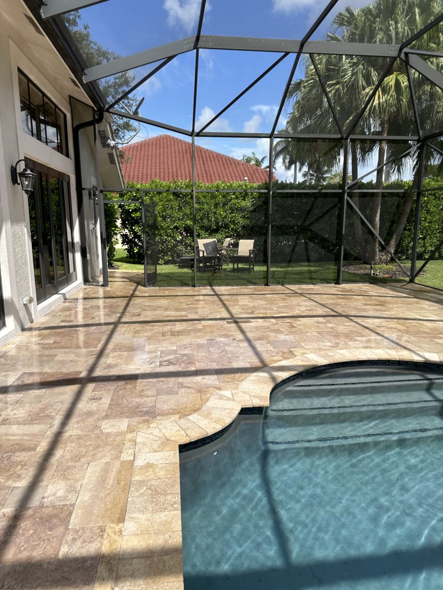 Paver walkway mid-clean in South Florida — black mildew on one side, clean pavers on the other