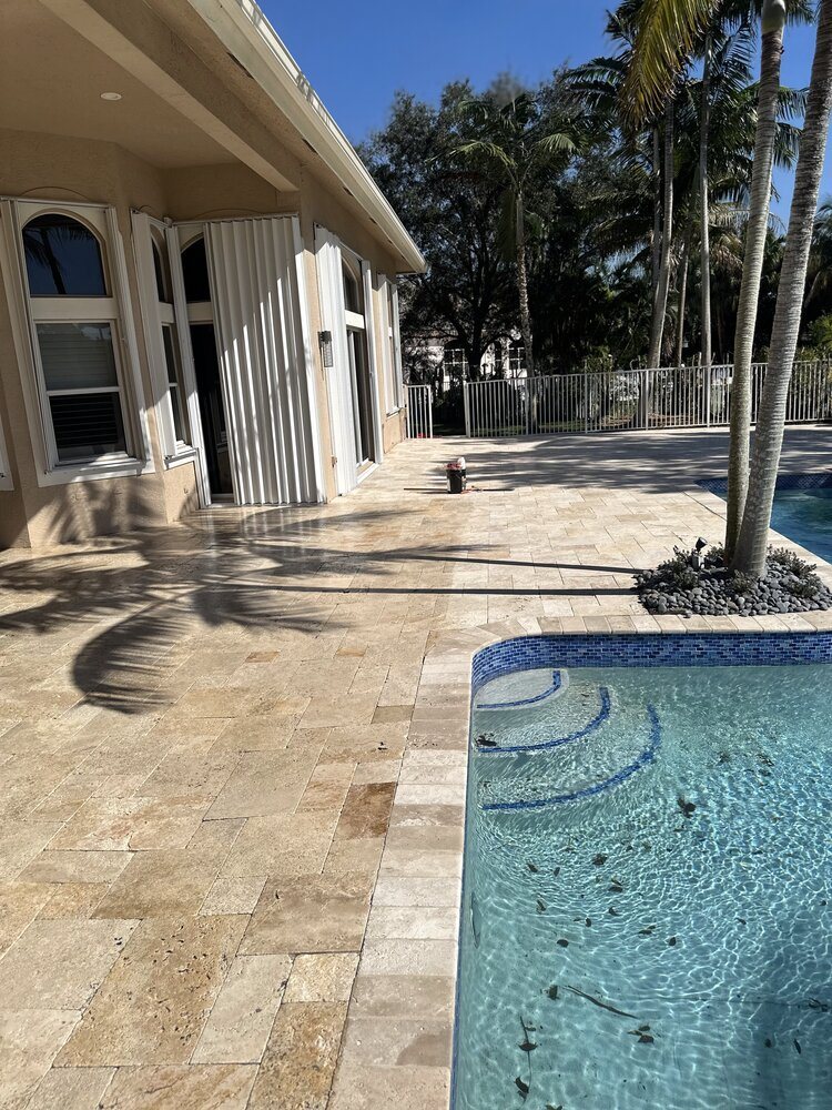 Clean, sealed pool deck and spa at a South Florida home