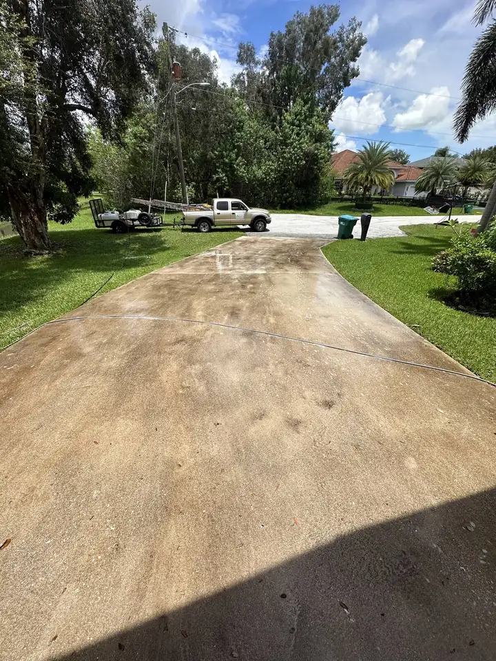 Rust-stained concrete driveway in South Florida — before