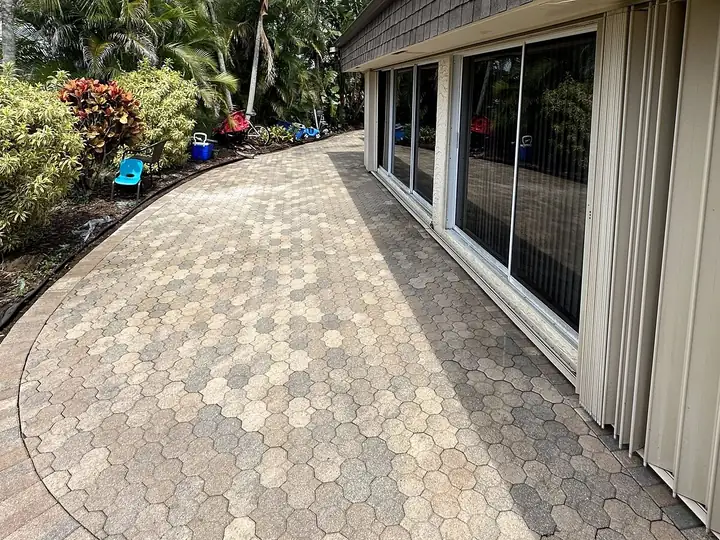 Clean paver walkway beside a South Florida home after soft washing — after