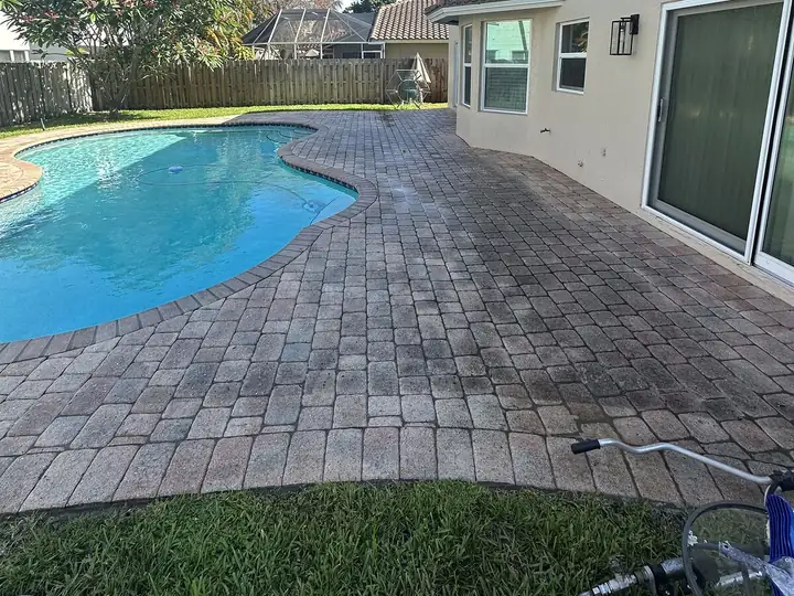 Paver pool deck dulled by mildew in South Florida — before