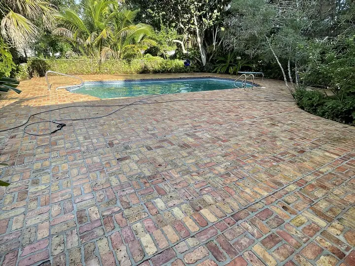 Brick paver pool deck in South Florida after pressure washing — after