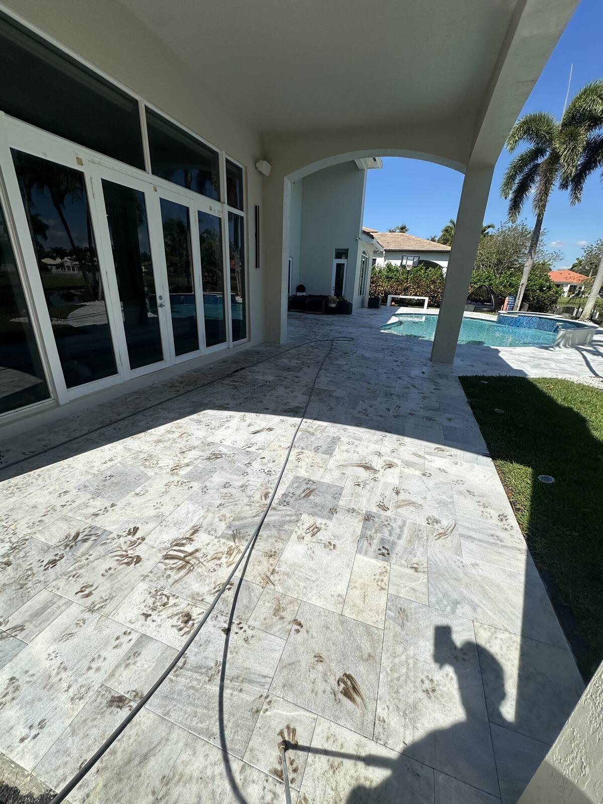 Dirty marble pool deck before pressure cleaning in Weston, FL