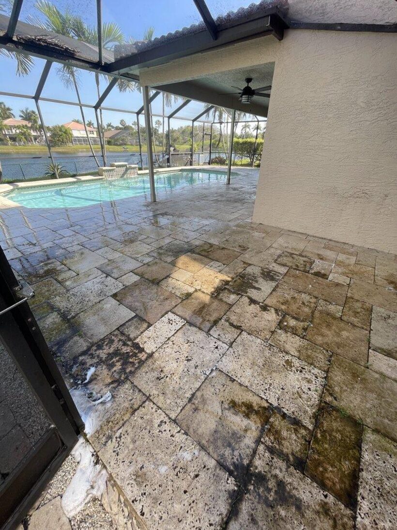 Dirty travertine pool deck before pressure cleaning in Weston, FL